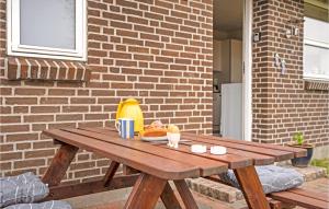a wooden picnic table with a bowl of food on it at Nice Apartment In Bindslev With Wifi in Bindslev