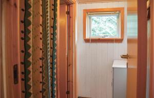 a small bathroom with a window and a door at 4 Bedroom Stunning Home In Thisted in Thisted