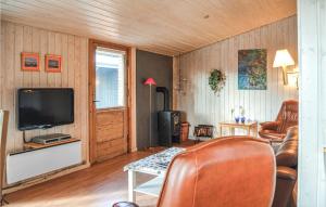 a living room with a couch and a television at 4 Bedroom Stunning Home In Thisted in Thisted