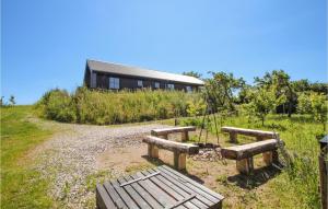 a group of benches in front of a building at 3 Bedroom Gorgeous Home In Samsø in Toftebjerg