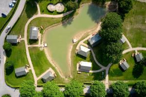 an aerial view of a park with trees and a road at Safaritenten Betuwe in Kesteren