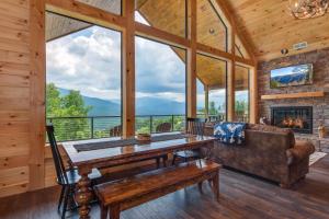 a living room with a table and a couch and a fireplace at Southern Stars by Stony Brook Cabins in Rocky Grove