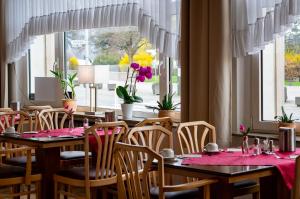 a dining room with tables and chairs and a window at Hotel zum Anker in Andernach +22 photos