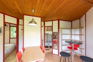 a room with a table and chairs and a bed at Bungalow Moulin Du Gournier in Malbosc