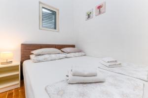 Postel nebo postele na pokoji v ubytování Apartments Gisela