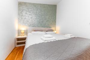 Postel nebo postele na pokoji v ubytování Apartments Gisela