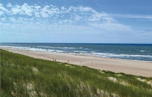 a beach with people walking on the sand and the ocean at Holiday Home Tingodden Denm I in Hvide Sande +19 photos