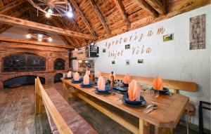 a dining room with a long wooden table with paper boats on it at Lovely Home In Rivalno With Sauna in Slanje +53 photos