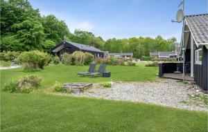 a yard with two chairs and a house at Holiday Home Pøt Strandby Juelsminde Ii Dnkm in Sønderby +22 photos