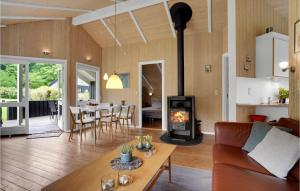 a living room with a couch and a wood stove at Holiday Home Pøt Strandby Juelsminde Ii Dnkm in Sønderby