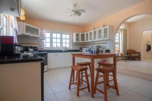 a kitchen with a table and two bar stools at Beautiful Luxury Home in Seroe Colorado in Ceru Colorado