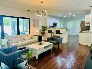a living room with a couch and chairs and a table at Cozy Bedroom Suites in Beautiful Shared Home in Matthews
