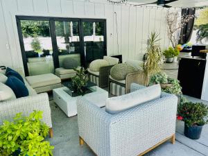 a patio with chairs and tables and potted plants at Cozy Bedroom Suites in Beautiful Shared Home in Matthews
