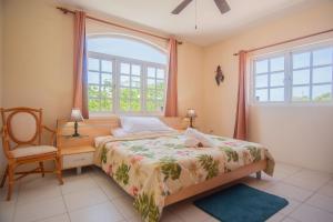 a bedroom with a bed and a chair and a window at Beautiful Luxury Home in Seroe Colorado in Ceru Colorado