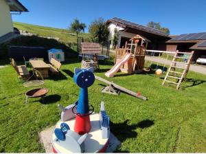 a playground with a cat toy on the grass at Ferienhof Broger FeWo Bergblickle mit Pool in Neukirch