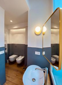 a bathroom with a sink and two toilets and a mirror at Dimora Donna Maria Relais in Cava deʼ Tirreni +43 photos