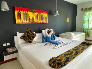a bedroom with a large white bed in a room at AVO Boutique Hotel in Dikoni