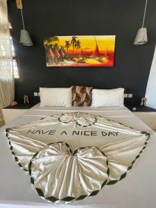 a bedroom with two beds with a nice day poster on the wall at AVO Boutique Hotel in Dikoni