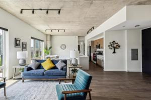 a living room with a blue couch and a kitchen at 3BR Luxury Modern Apartment in Chicago