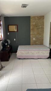 a bedroom with a bed in the corner of a room at Sítio Paraíso in Cachoeiras de Macacu +3 photos