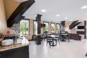 a kitchen and dining room with tables and chairs at Chester Inn in Gastonia