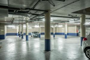 a parking garage with columns and cars parked in it at Hotel Antik San Sebastián in Donostia-San Sebastián