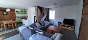 a living room with a couch and a tv and a table at Chez Marianne in Quiberon