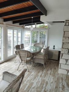 Un comedor con una mesa de cristal y sillas. en Alacati villa, en Cesme