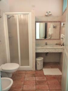 a bathroom with a toilet and a sink and a shower at Il Casolare Country House in Fontecorniale