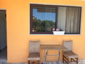 a table and two chairs in front of a window at Welcome Guest House in Shkodër