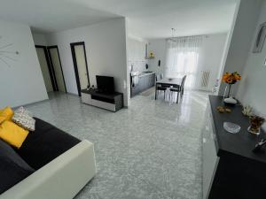 a living room with a couch and a dining room at Apulian Apartment in Valenzano