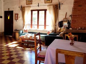 a living room with a table and a couch at La Paleta del Pintor Hosteria in Maimará +181 photos
