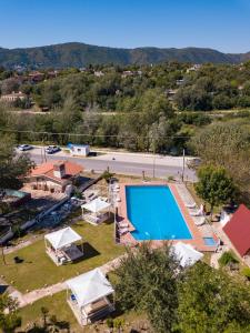 an overhead view of a swimming pool with tents at La Martinica in Villa Carlos Paz