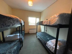 Postel nebo postele na pokoji v ubytování Hostel Punto Patagónico Bariloche