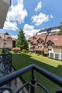 a view from the balcony of a house with a golf course at Apartment Valt & Spa in Zlatibor
