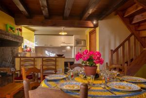 a dining room with a table with plates and glasses at Gîte Gîtes de France 6/7 personnes à Baboyères in Nasbinals +27 photos