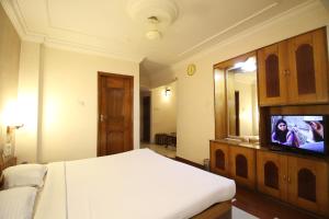 Ένα ή περισσότερα κρεβάτια σε δωμάτιο στο Hotel Grand Arjun