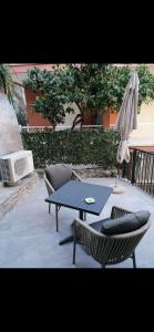 a patio with a table and chairs and an umbrella at Casa Edera in Monterosso al Mare