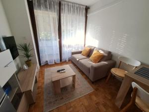 a living room with a couch and a table at Apartman Tamara in Zadar