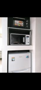 a microwave oven sitting on top of a refrigerator at Casa Edera in Monterosso al Mare