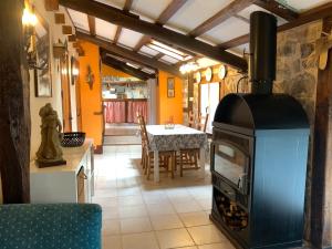 a kitchen and dining room with a wood stove at Apartamento Rustico El Cerezo in Lubayo