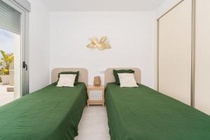 two beds sitting next to each other in a room at Casa Dorada in Altea +17 photos