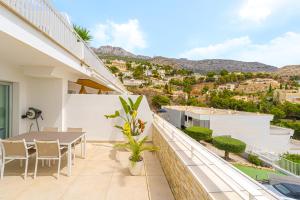 a balcony of a house with a table and chairs at Casa Dorada in Altea