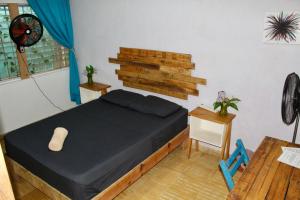 a small bedroom with a bed and a table at Casa Samay in Cozumel +28 photos