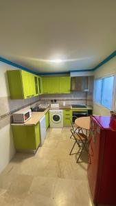 a kitchen with lime green cabinets and a table at Loving Mediterranean Home in Estepona