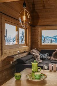a living room with a table with cups on it at Les Chalets-H&ocirc;tel de la Croix-Fry in Manigod