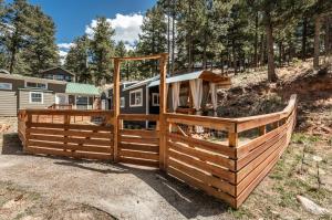 a wooden fence in front of a house at Glamping Under the Stars Firepit, BBQ & Views in Woodland Park