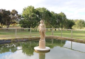 a statue of a woman standing in a pond at Manjimup Gateway Hotel in Manjimup