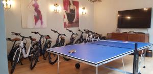 a ping pong table in front of a group of bikes at Les Cabines in Houlgate