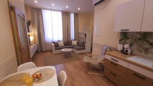 a room with a kitchen and a living room at Center Apartments Tukums in Tukums